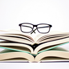 glasses on a pile of books
